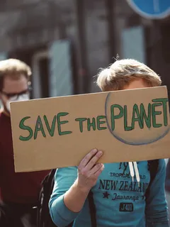 Woman holding 'Save the Planet' sign at global climate strike, March 25, 2022