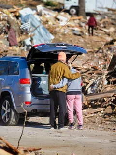 Couple comforting each other after losing home in December 2021 tornado