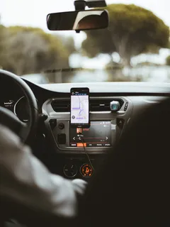 Smartphone mounted securely on car dashboard holder