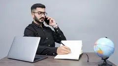Man holding pen, book, and laptop for business or study purposes