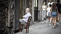 Man sitting on chair in doorway relaxed pose